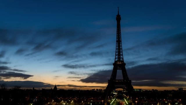 Night to Day timelapse of Eiffel tower in winter from Trocadero on a cloudy day - Paris, France.