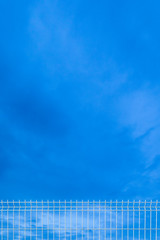 white industrial fence to the sky