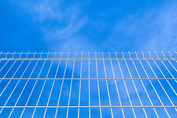 white industrial fence to the sky