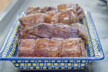Big pieces grilled beef on color plate. Close up. Soft focus