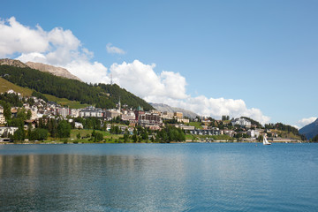 Fototapeta na wymiar Sankt Moritz town, lake and sail boat in a sunny summer day in Switzerland