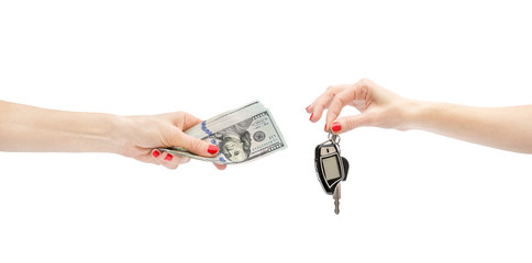 Hand giving money to other hand which holding car keys. Isolated on white. Buying car.