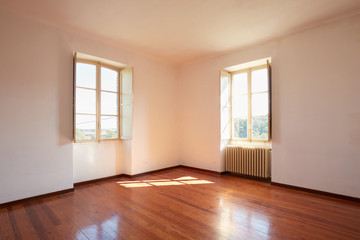 Old room with wooden floor in a country house, sunlight