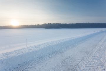 Winter landscape at sunrise with road