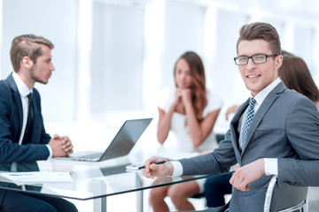 young businessman with his business team sitting at his Desk