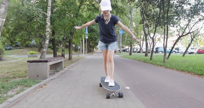 The child learns to skateboard in the park.
