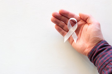 man hold white ribbon with place for text on white background