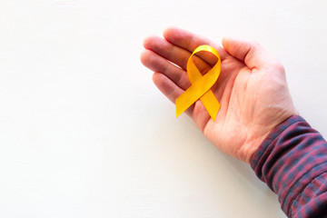 man hold yellow ribbon with place for text on white background