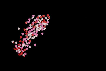 Pink, red  and white hearts sugar on a black background.Valentine's Day concept with copy space. - Image