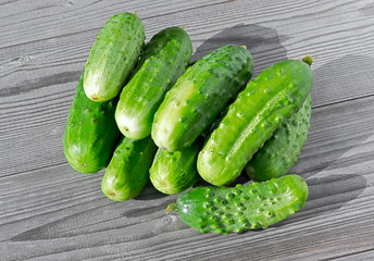 Cucumber. Heap of fresh green Cucumbers isolated on a wooden.