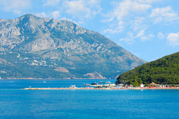 St. Nicholas island near Budva in Montenegro. Coast with blue sea, rocks and sky with clouds