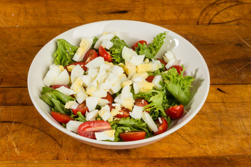 Mixed Salad with Tomatoes and Boiled Egg in Rustic Setting
