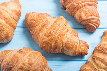Croissants on wooden background