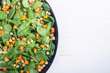 autumn salad with pumpkin , spinach , chickpea and sesame