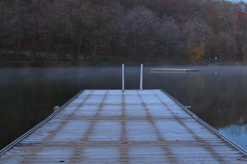 Frosty Winter Morning on the Lake. Dock on the lake in winter morning.