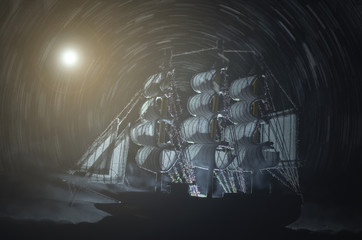 Pirate ghost ship in a night smoky sea background.