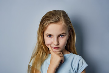 portrait of a girl, shows emotions on the face, on a blue background