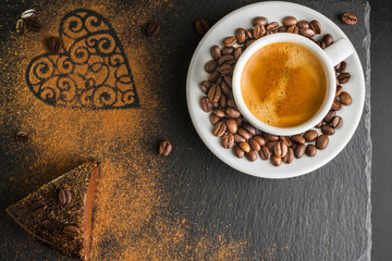 Chocolate cake and espresso coffee on a slate background.