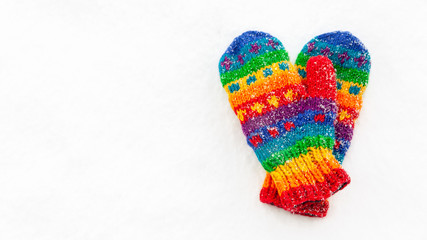 Pair of colorful mittens in the snow