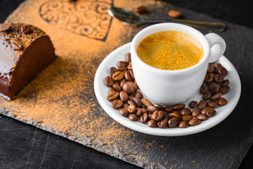 Chocolate cake and espresso coffee on a slate background.
