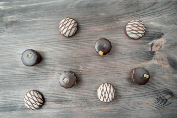 top view of various chocolate candies on wooden background