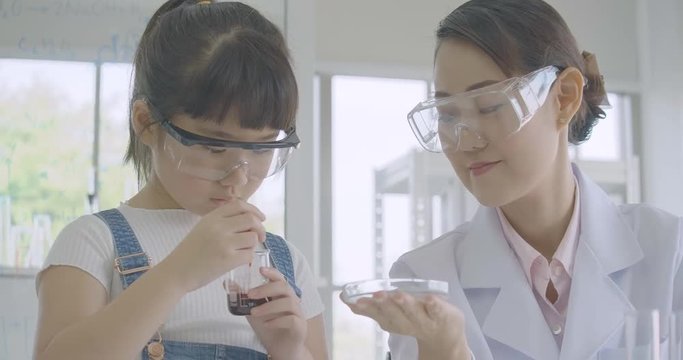 Little Asian student girl learning in science experiment laboratory class. Science and education.