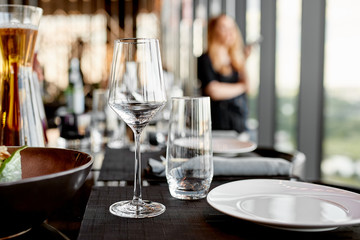 Empty glass goblets and table setting in the restaurant