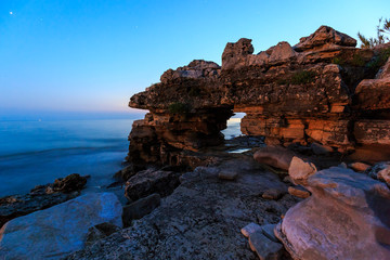 Enjoying the colorful sunset on a beach with rocks on the Adriatic Sea coast Istria Croatia