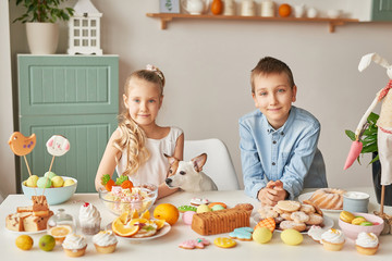 Easter greeting card with gingerbread cookies and eggs. Easter Postcard Template. Cookies in shape of eggs and bunny. Happy Easter holiday concept, kids with easter gingerbread cookies and dog