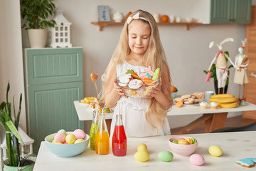Easter greeting card with gingerbread cookies and eggs. Easter Postcard Template. Cookies in shape of eggs and bunny. Happy Easter holiday concept, girl with easter gingerbread cookies and eggs