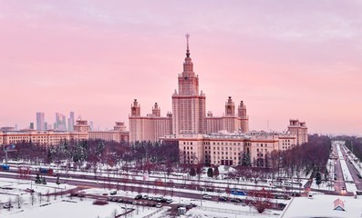Fototapeta na wymiar Vibrant aerial panorama of winter campus of famous sunset university with snowed trees in Moscow