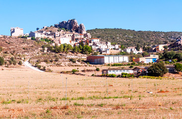 Rural village in the north of Spain surrounded by cultivated fields on a sunny day.