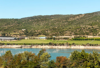 Lake in the mountains of the Pyrenees with mountains to the background in Catalonia, Spain on a sunny day.