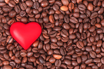  Flat lay of red heart on the background of coffee beans.Сoncept of love, holidays