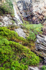River in the mountains of the Swiss Alps in the Saint Luc valley on a sunny day.
