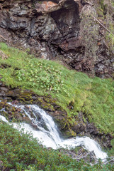 River in the mountains of the Swiss Alps in the Saint Luc valley on a sunny day.