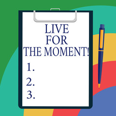 Conceptual hand writing showing Live For The Moment. Business photo showcasing Enjoy today happy lifestyle relaxed be motivated Sheet of Bond Paper on Clipboard with Ballpoint Text Space