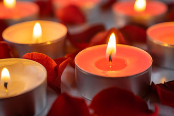 Obraz na płótnie Canvas Scented candles with rose petals, warm and cozy background