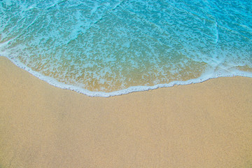 Naklejka na ściany i meble Soft waves on the sandy beach.