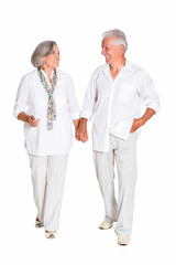 Senior couple holding hands isolated on white background, full length