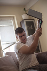 Adult man frustrated with laptop.