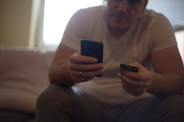 Man is shopping online with smartphone .