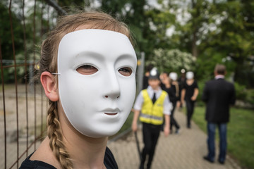 Masked girl in a school event.