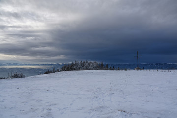 Fototapeta premium Summit cross on mountain Schockl in winter, Austria