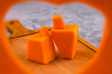 Stylized human figures carved from a pumpkin. Frame in the shape of a heart. The symbol of mutual love.