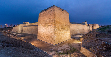 Evening view of illuminated Bahrain Fort (Qal'at al-Bahrain) in Bahrain