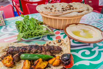 Local food (kabab, bread and hummus) at the central Souq in Kuwait City