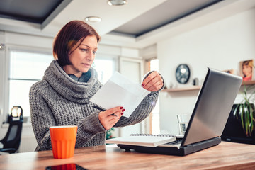 Woman opening letter in the office