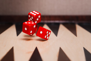 Dice are thrown on the playing Board.  Bones in the air.