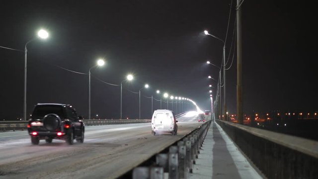 Accelerated Movement, Streaming Cars Moving along the Snow Bridge at Night